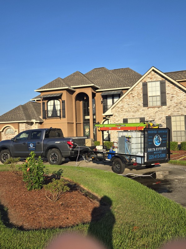 Delta Exterior Washing's branded truck and wash trailer at a residential home