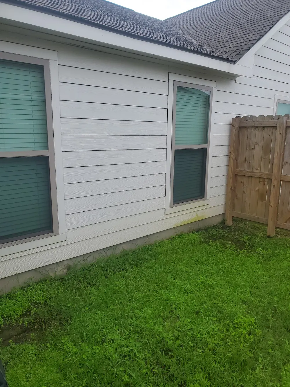 Clean white siding corner after a wash