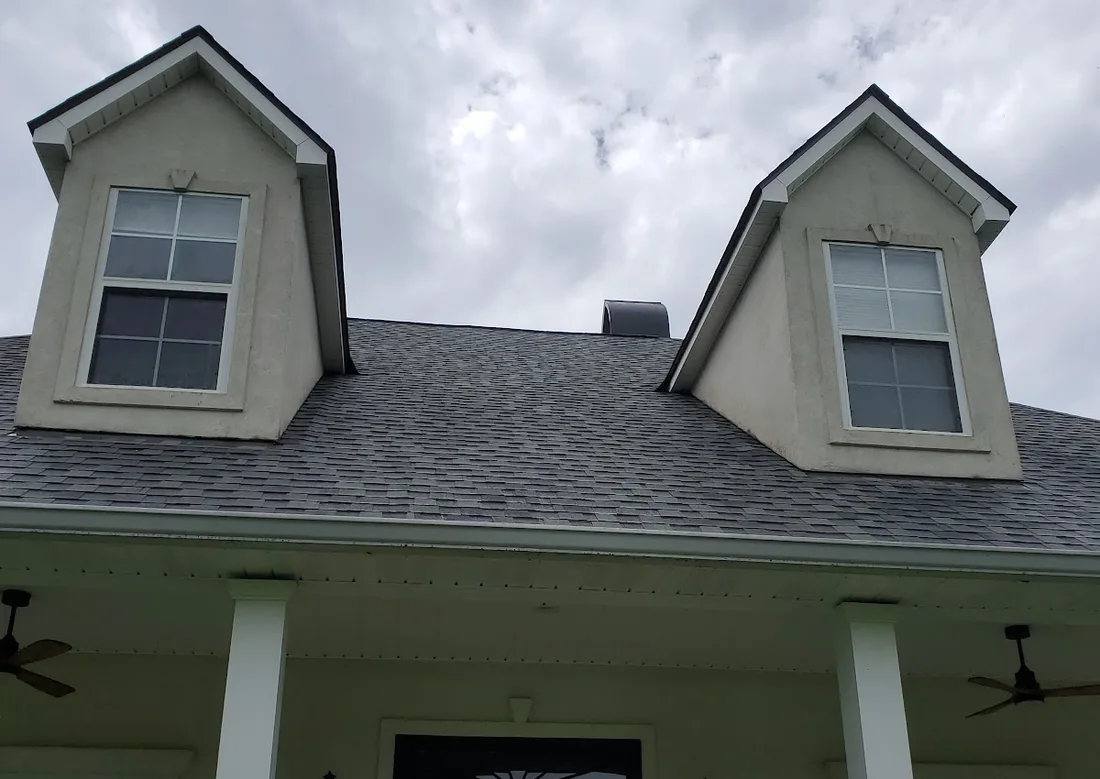 A finished home front with clean dormers, roofline and covered porch