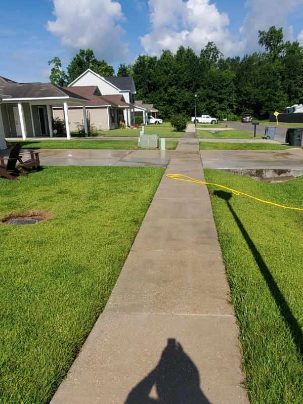 The same residential sidewalk after washing