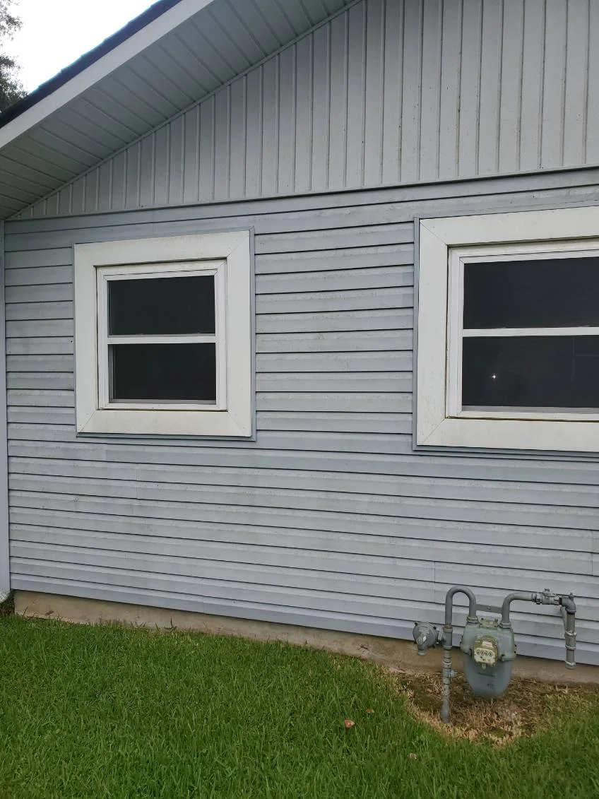 Clean siding around two windows